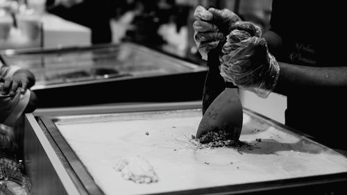 Midsection of man holding ice cream in restaurant