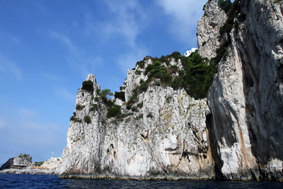 Low angle view of rock formation against sky