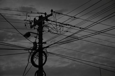 Low angle view of electricity pylon against sky