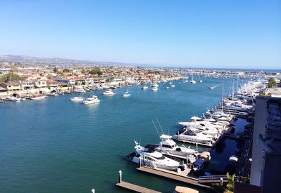 High angle view of cityscape by sea against sky