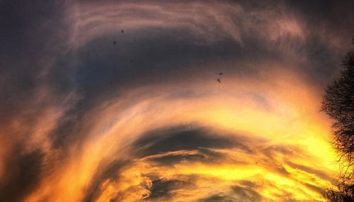 Low angle view of dramatic sky during sunset