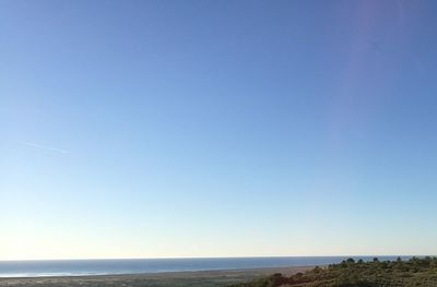 Scenic view of sea against clear blue sky