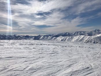 Scenic view of snowcapped mountains against sky