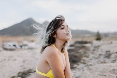 Portrait of woman standing on beach