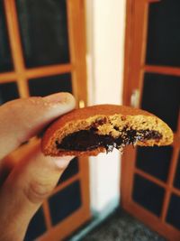 Close-up of hand holding cake