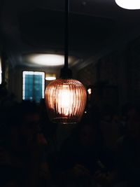 Illuminated light bulbs hanging from ceiling