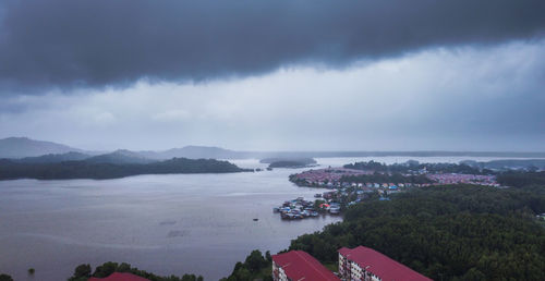 High angle view of cityscape by sea against sky