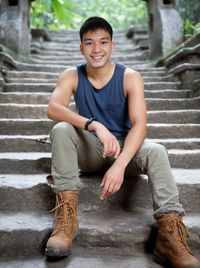 Portrait of young man sitting on steps