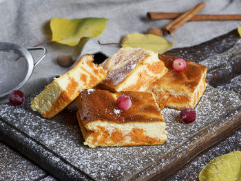 Close-up of cheesecake slices with kitchen knife on table