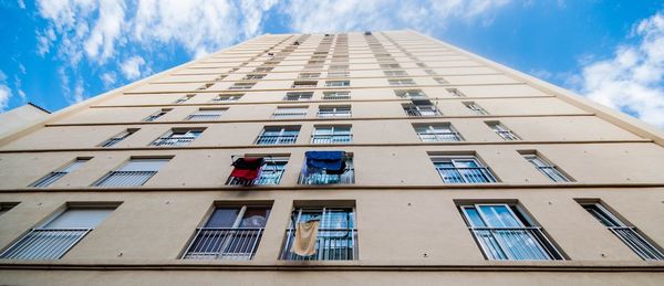 Low angle view of office building against sky