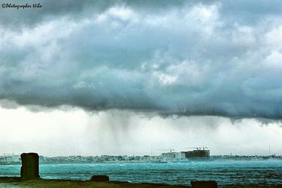 Scenic view of sea against storm clouds