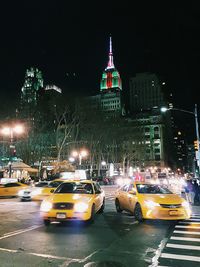 Illuminated city street at night