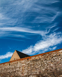 Low angle view of building against blue sky during sunny day