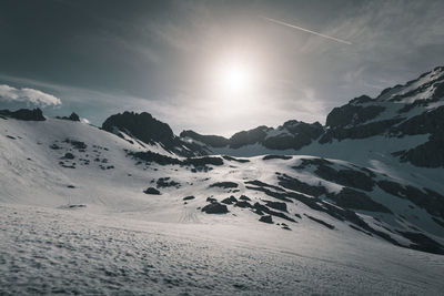 Scenic view of snow covered mountains against sky