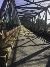 Footbridge against sky in city