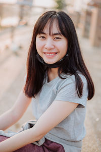 Portrait of smiling woman sitting outdoors