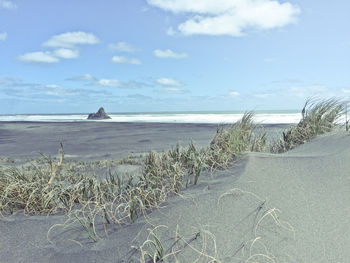 View of calm beach against sky