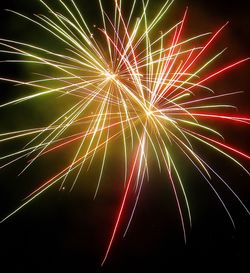 Low angle view of firework display at night