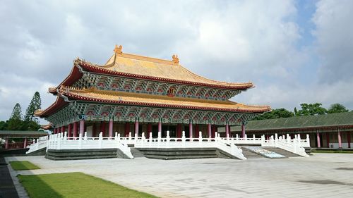 Temple building against cloudy sky