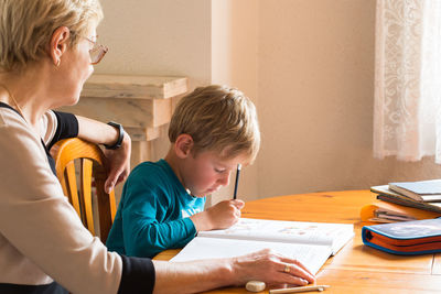 Boy sitting on table