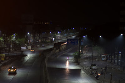 Cars on city street at night