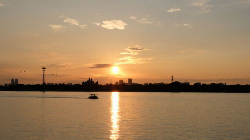 Scenic view of lake against sky during sunset