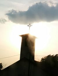 Low angle view of silhouette cross against sky during sunset