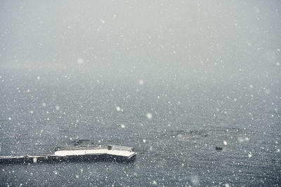 Spectacular seascape with pier during snowfall