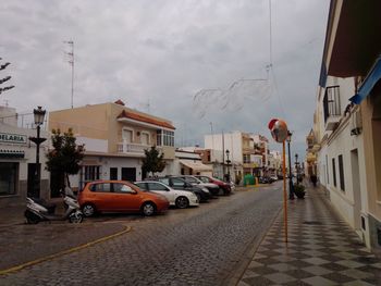 Street amidst buildings in city against sky