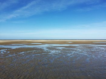 Scenic view of landscape against blue sky