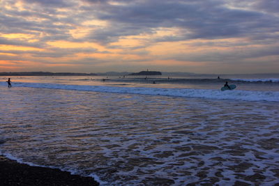 Scenic view of sea against cloudy sky