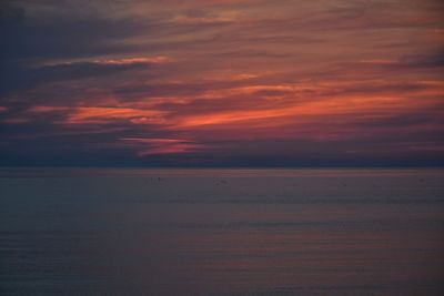 Scenic view of sea against orange sky