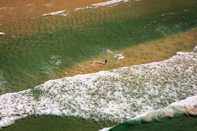 Aerial view of man surfboarding on sea