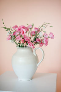 Close-up of pink flower vase on table