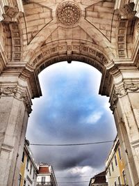 Low angle view of building against cloudy sky