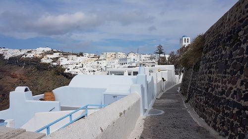 Buildings in town against sky