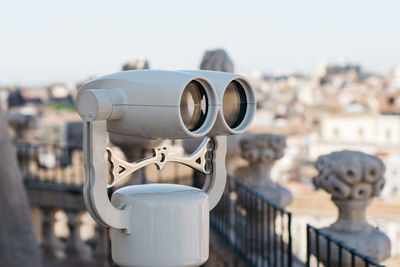 Close-up of coin-operated binoculars against sky