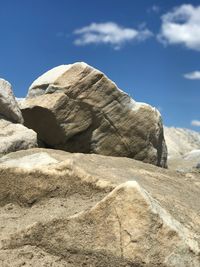 Low angle view of rock formations against sky