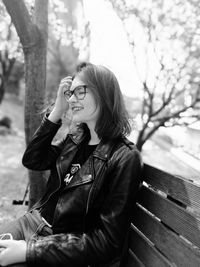 Young woman sitting on bench at park