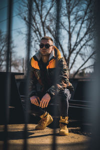 Full length of man sitting in snow