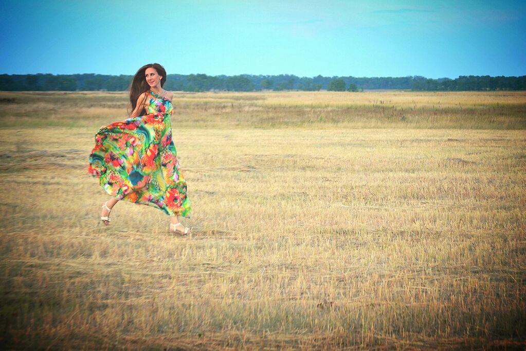 field, landscape, grass, clear sky, rural scene, leisure activity, person, agriculture, sky, lifestyles, casual clothing, tranquility, full length, nature, grassy, tranquil scene, portrait, horizon over land