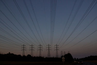 Low angle view of electricity pylon against sky