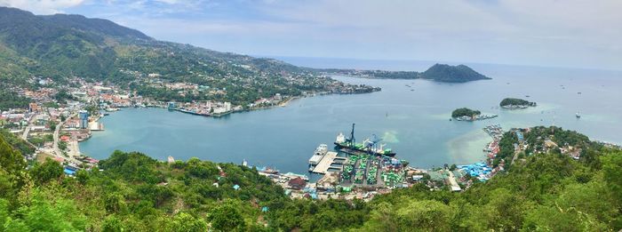 High angle view of buildings and sea against sky