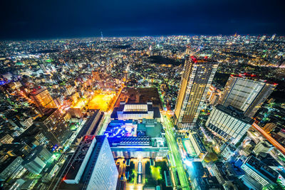 Aerial view of illuminated buildings in city at night