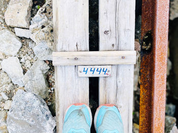 Aqua blue sneakers hiking 4444 steps, wooden stairway. goals completed.