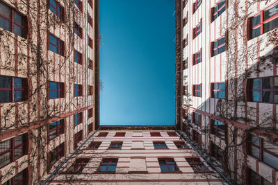 Low angle view of buildings against clear blue sky