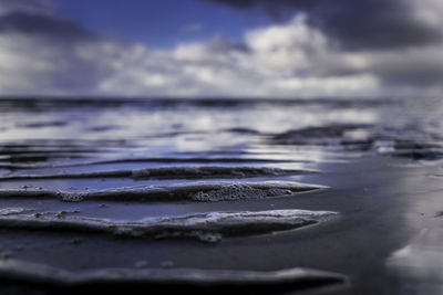 Surface level of sea shore against sky