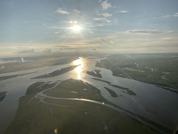 Aerial view of landscape against bright sun