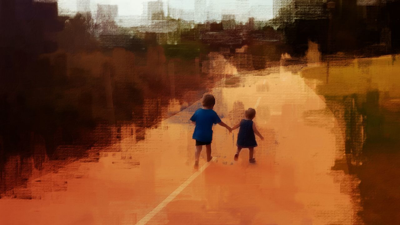 Rear view of siblings walking on street