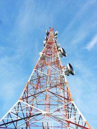 Low angle view of communications tower against blue sky